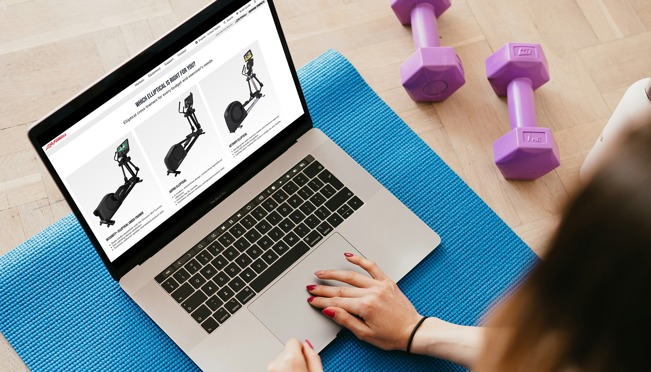 Woman browsing exercise equipment on laptop